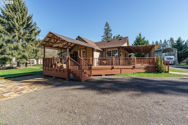 view of front of property featuring a carport and a wooden deck