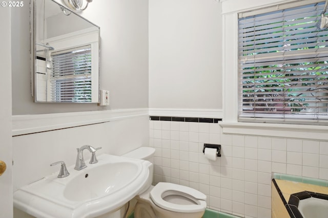 2083 NW Johnson St Unit 21, Portland, OR 97209 - bathroom featuring tile walls, a wainscoted wall, and a shower