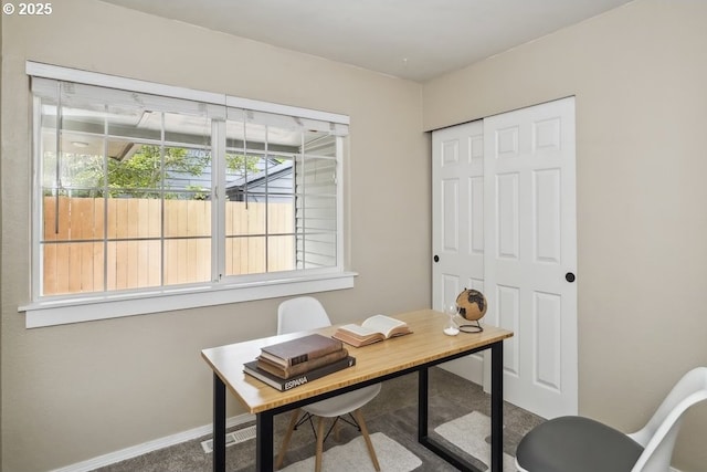 carpeted office space featuring baseboards