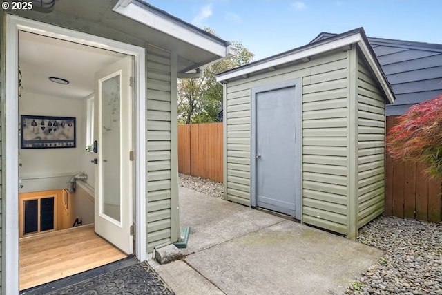 view of shed featuring fence