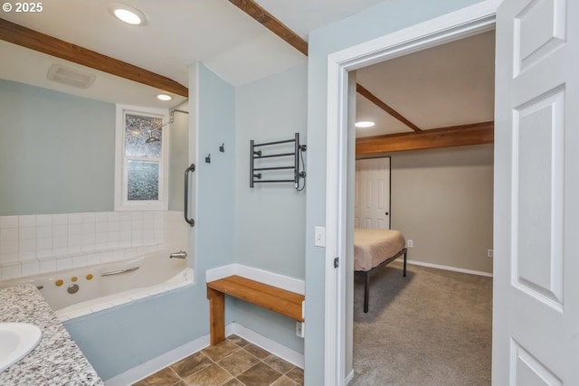 bathroom featuring a tub, baseboards, recessed lighting, and a sink