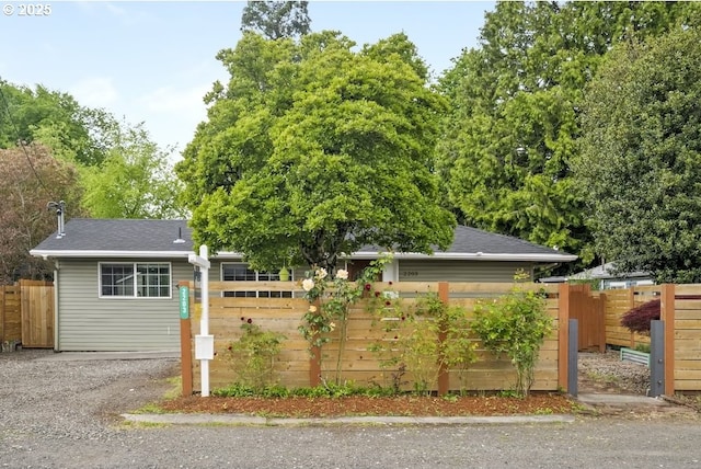 ranch-style home featuring roof with shingles