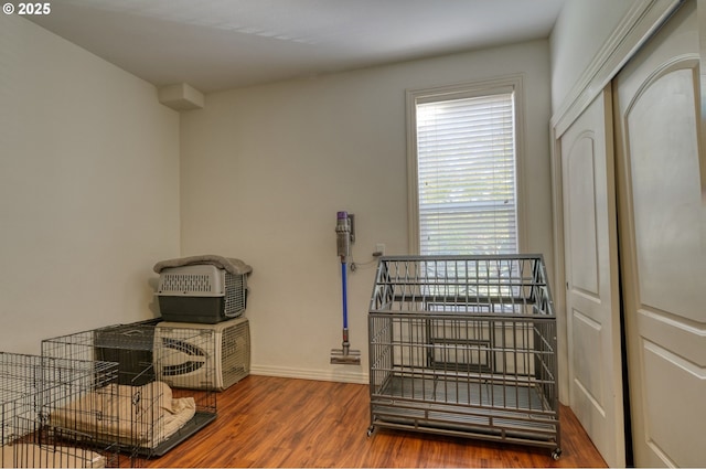 miscellaneous room featuring baseboards and wood finished floors