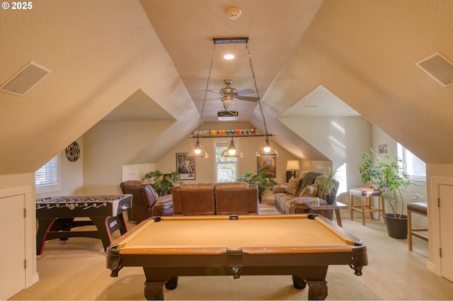 rec room with lofted ceiling, ceiling fan, a healthy amount of sunlight, and light colored carpet