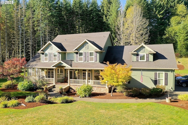 view of front of home with a front yard and covered porch