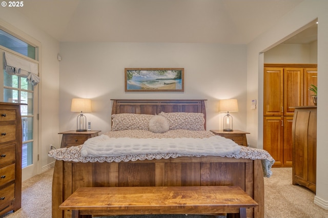 bedroom featuring baseboards and light colored carpet