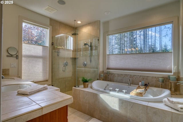 bathroom with visible vents, a sink, a shower stall, a bath, and tile patterned floors