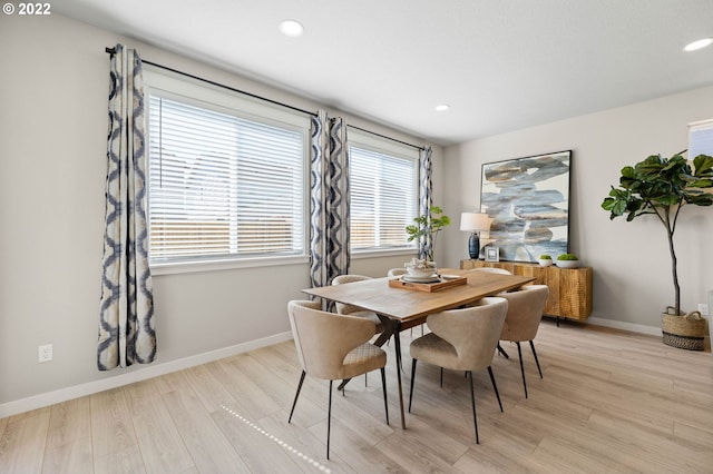 dining space with light wood finished floors, baseboards, and recessed lighting