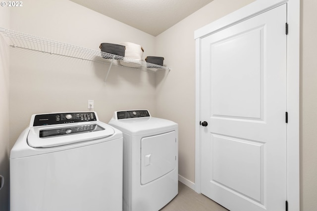 laundry room featuring laundry area and washing machine and clothes dryer