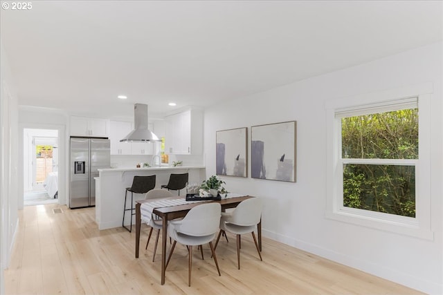dining area with recessed lighting, baseboards, and light wood-type flooring