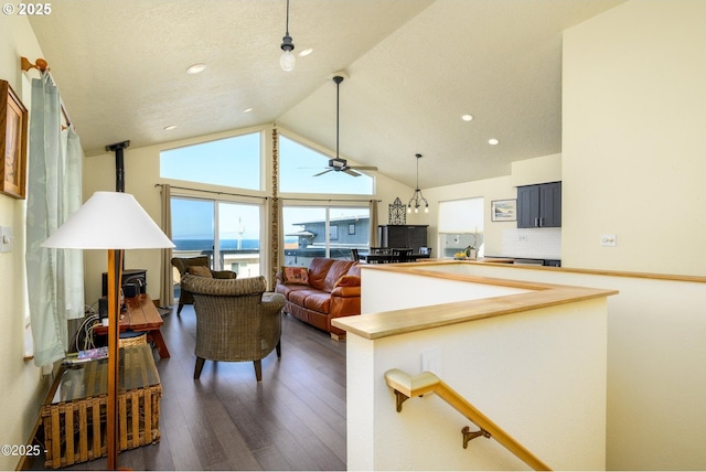 6431 NE Mast Ave, Lincoln City, OR 97367 - living room featuring ceiling fan, a wood stove, recessed lighting, and dark wood-type flooring