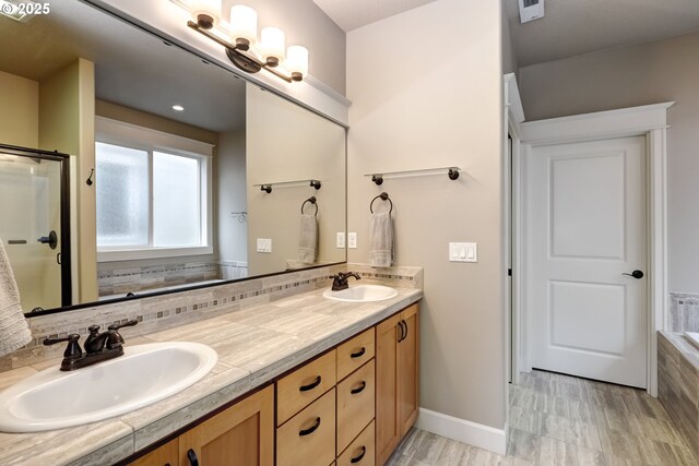 9350 SW Gertz Ln, Tualatin, OR 97062 - bathroom with double vanity, a shower with shower door, and baseboards