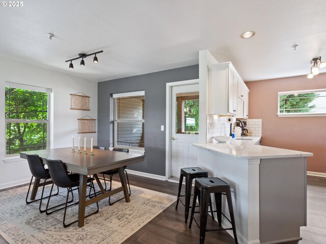 12130 NE Fremont St Unit 4, Portland, OR 97220 - kitchen featuring light countertops, white cabinetry, a breakfast bar, healthy amount of natural light, and recessed lighting