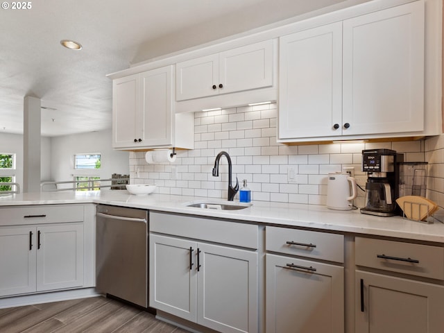 12130 NE Fremont St Unit 4, Portland, OR 97220 - kitchen featuring stainless steel dishwasher, tasteful backsplash, a peninsula, light wood finished floors, and gray cabinetry