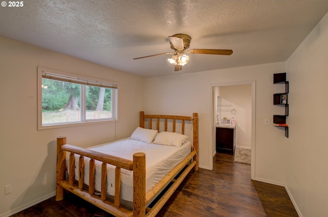 82548 Vinemaple Rd, Seaside, OR 97138 - bedroom with dark wood-style flooring, a textured ceiling, and a ceiling fan