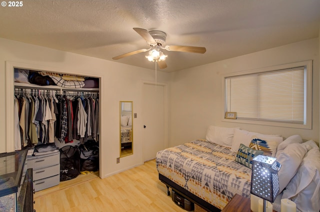 82548 Vinemaple Rd, Seaside, OR 97138 - bedroom with a closet, light wood finished floors, a ceiling fan, and a textured ceiling
