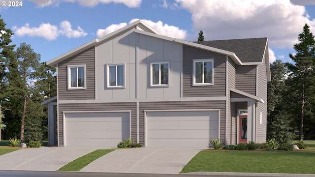 view of front facade with a front yard and a garage