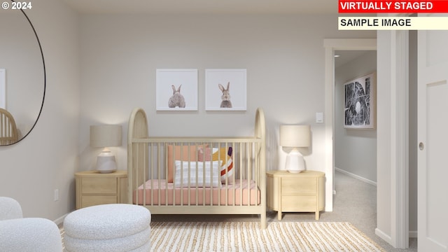 bedroom featuring a crib and carpet flooring