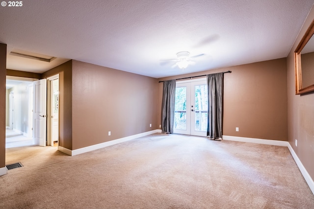 6900 SW Preslynn Dr, Portland, OR 97225 - empty room featuring light carpet, a ceiling fan, baseboards, a textured ceiling, and attic access