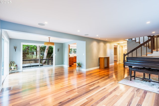 6900 SW Preslynn Dr, Portland, OR 97225 - living room featuring plenty of natural light, light wood-style flooring, stairs, baseboards, and recessed lighting