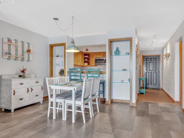 1 3rd St Unit 204, Astoria, OR 97103 - dining space featuring rail lighting, baseboards, and washer / clothes dryer