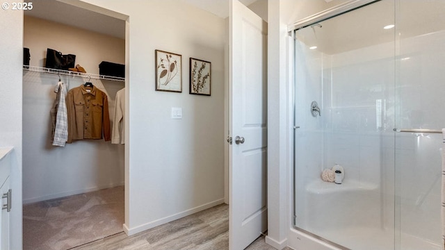 262 Greencrest St, Salem, OR 97301 - full bath with a stall shower, a walk in closet, vanity, and wood finished floors