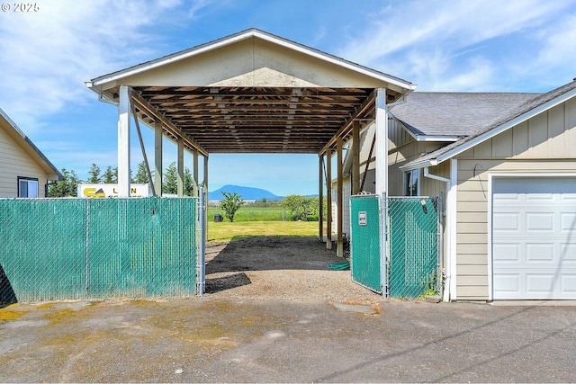 4750 SW 3rd St, Corvallis, OR 97333 - view of parking with a carport, fence, and a mountain view