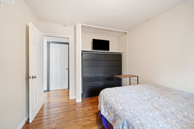 bedroom with baseboards and light wood finished floors