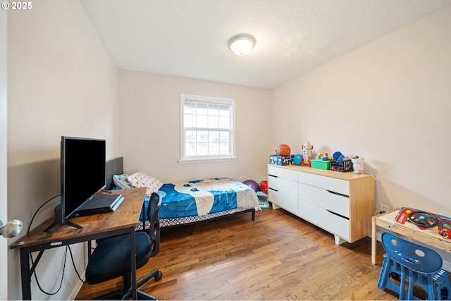 bedroom featuring wood finished floors
