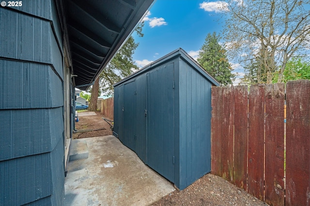 view of shed with fence