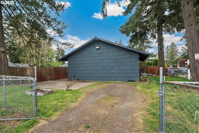view of side of property with a lawn, crawl space, a garden, and fence private yard