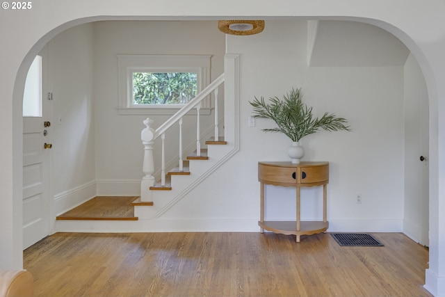 8052 NE Couch St, Portland, OR 97213 - staircase featuring arched walkways and wood finished floors
