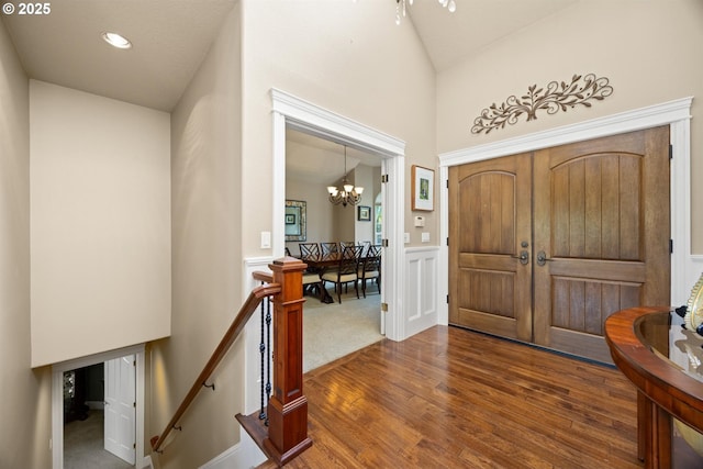 2130 S 26th Ave, Ridgefield, WA 98642 - foyer entrance with wood finished floors, a chandelier, a wainscoted wall, and vaulted ceiling