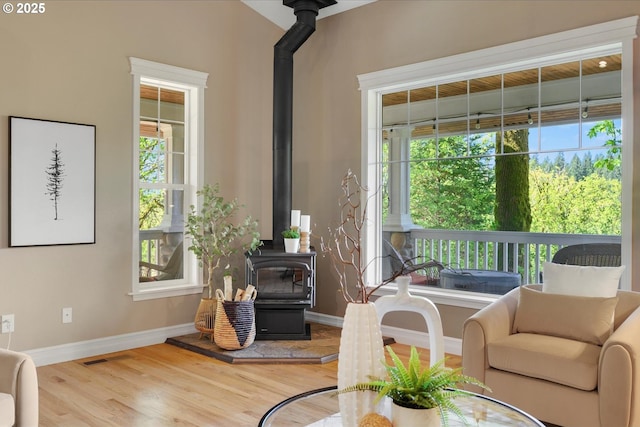 15564 S Neibur Rd, Oregon City, OR 97045 - living room with baseboards, visible vents, wood finished floors, and a wood stove