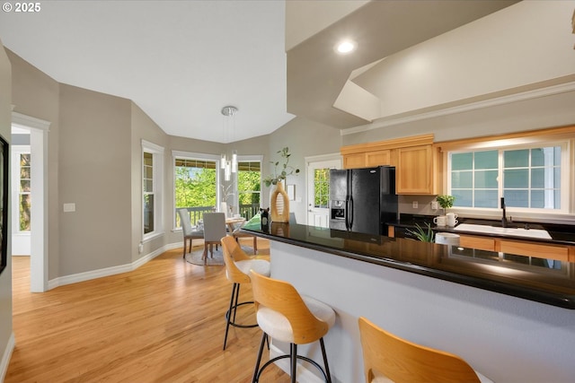 15564 S Neibur Rd, Oregon City, OR 97045 - kitchen with black fridge, a sink, recessed lighting, light wood-type flooring, and vaulted ceiling