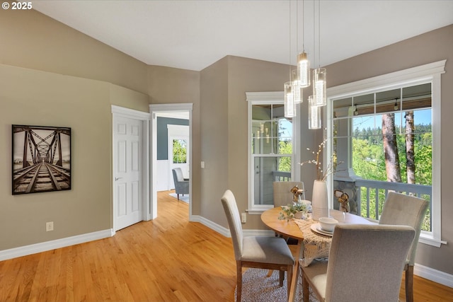 15564 S Neibur Rd, Oregon City, OR 97045 - dining room featuring baseboards, light wood-style floors, a notable chandelier, and a healthy amount of sunlight