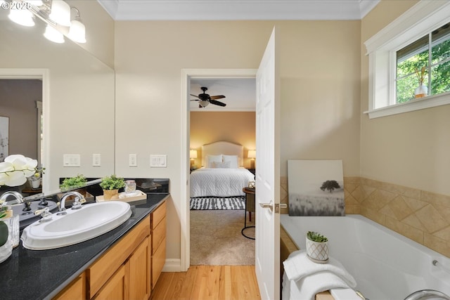 15564 S Neibur Rd, Oregon City, OR 97045 - bathroom with crown molding, a tub with jets, wood finished floors, vanity, and connected bathroom