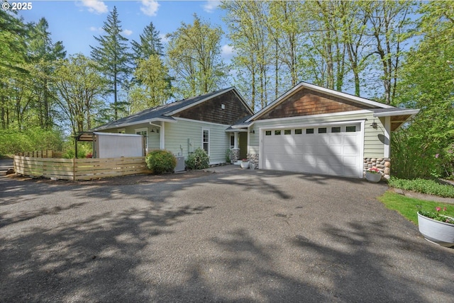 15564 S Neibur Rd, Oregon City, OR 97045 - view of front of property featuring a garage, stone siding, and aphalt driveway