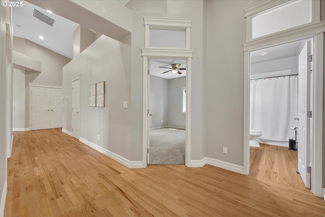 15564 S Neibur Rd, Oregon City, OR 97045 - hallway featuring visible vents, baseboards, light wood finished floors, and a towering ceiling