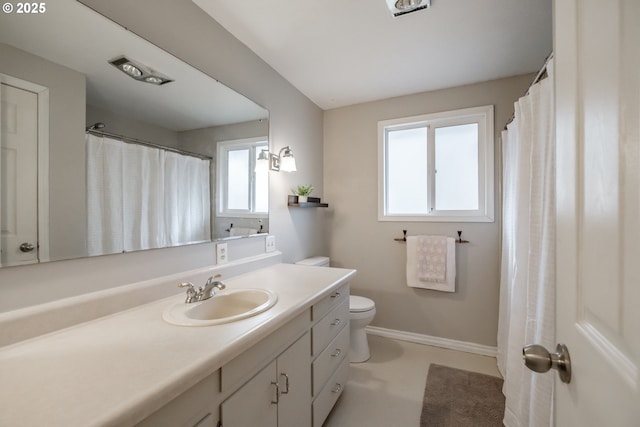 bathroom featuring toilet and vanity