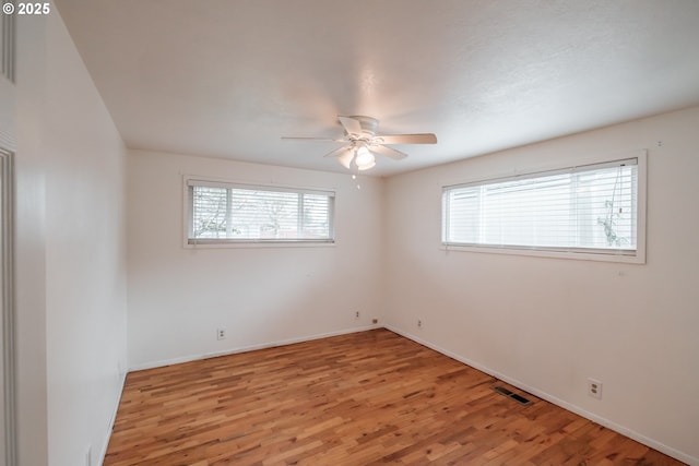 empty room featuring light wood-type flooring and ceiling fan