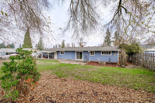 rear view of house with a yard and a patio