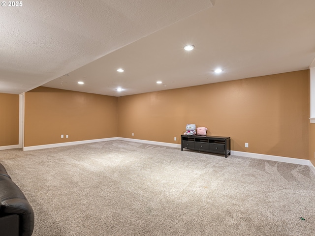 finished below grade area featuring carpet floors, recessed lighting, and baseboards