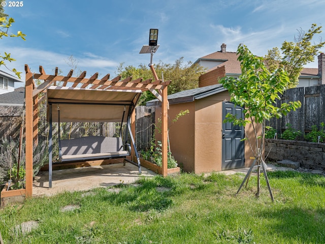 exterior space with a fenced backyard, a pergola, and an outdoor structure