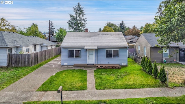 bungalow-style home featuring a chimney, fence, and a front yard