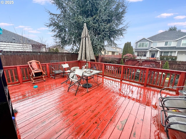 wooden terrace featuring a fenced backyard