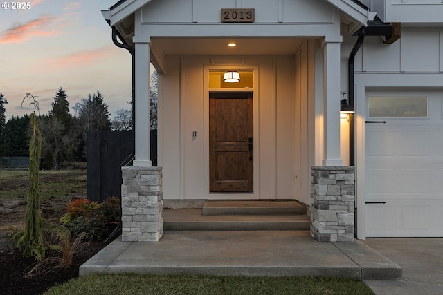 exterior entry at dusk with a garage