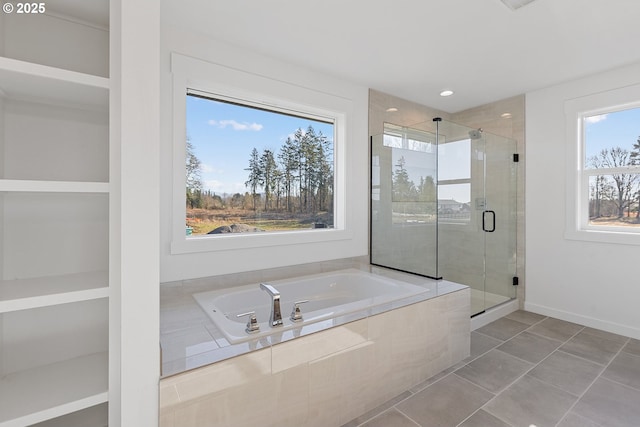 bathroom featuring tile patterned floors and shower with separate bathtub