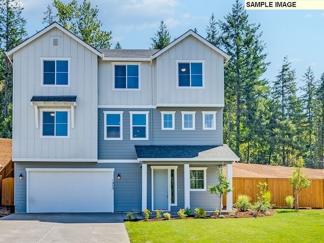 view of front of property featuring a garage and a front yard