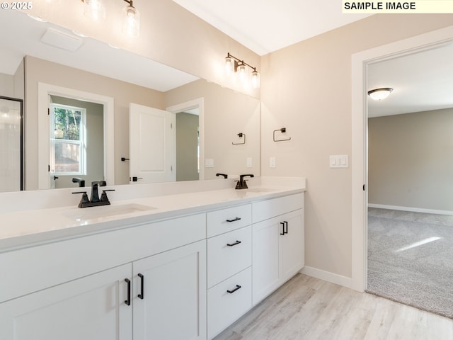 bathroom with vanity and wood-type flooring